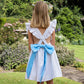 Ruffle cross-strap flower girl dress in ivory and blue by Amelia Brennan Weddings