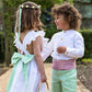 Linen Cross-Back Flower Girl Dress with Green Bow and matching Pageboy by Amelia Brennan