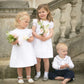 White cotton pintucked flowergirl dresses and Pageboy Outfit by Amelia Brennan Weddings