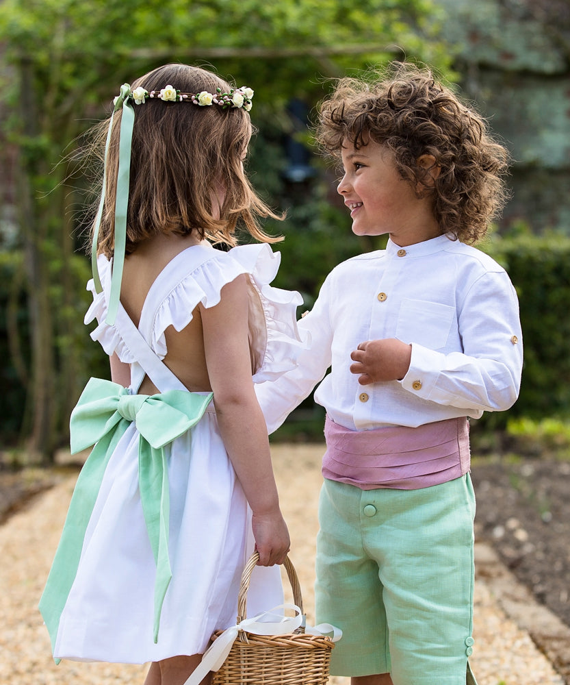 Linen Cross-Back Flower Girl Dress with Green Bow and matching Pageboy by Amelia Brennan