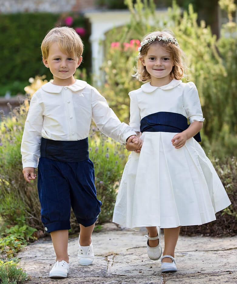 Pageboy and Bridesmaid in ivory and navy outfits by Amelia Brennan Weddings