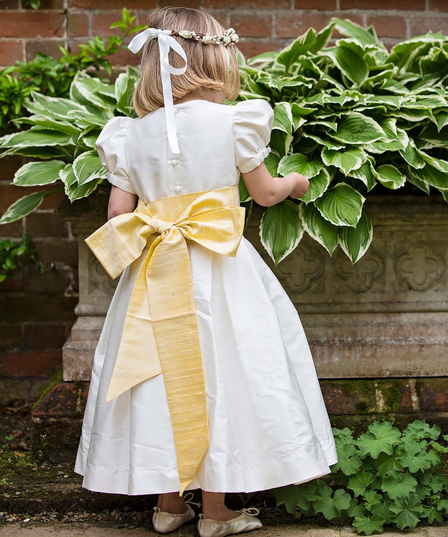 Ivory silk flower girl dress with long yellow sash