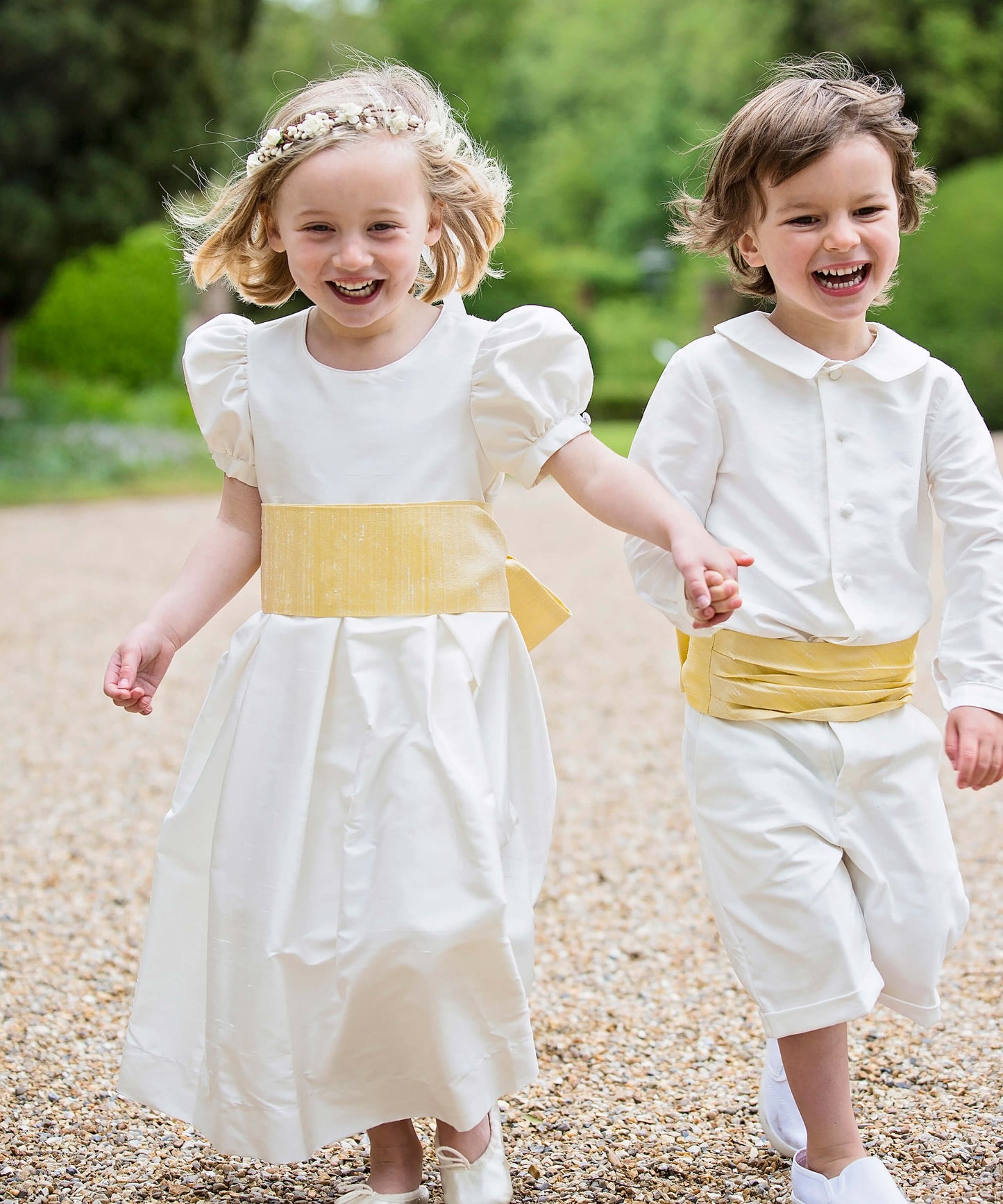 Pageboy and Bridesmaid in ivory and yellow outfits by Amelia Brennan Weddings