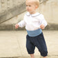 Toddler pageboy wears white peter pan collar shirt, navy knickerbockers and blue silk cummerbund
