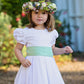White Dot Cotton Flower Girl Dress with Green Sash by Amelia Brennan Weddings