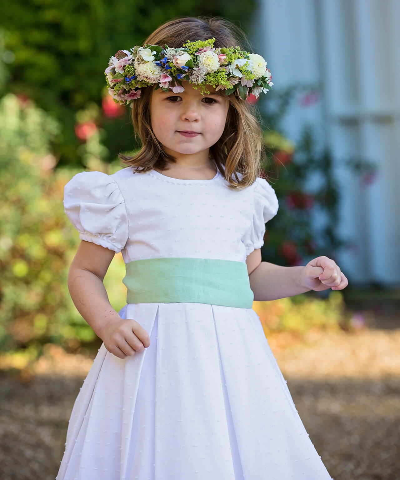 Flowergirl in dot cotton dress and green linen sash by Amelia Brennan Weddings